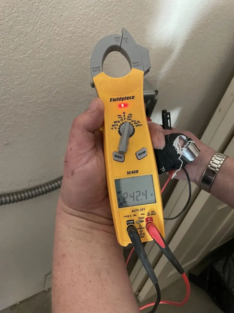 Voltage testing with clamp meter during Ceiling Fan Installation in Quantico Base